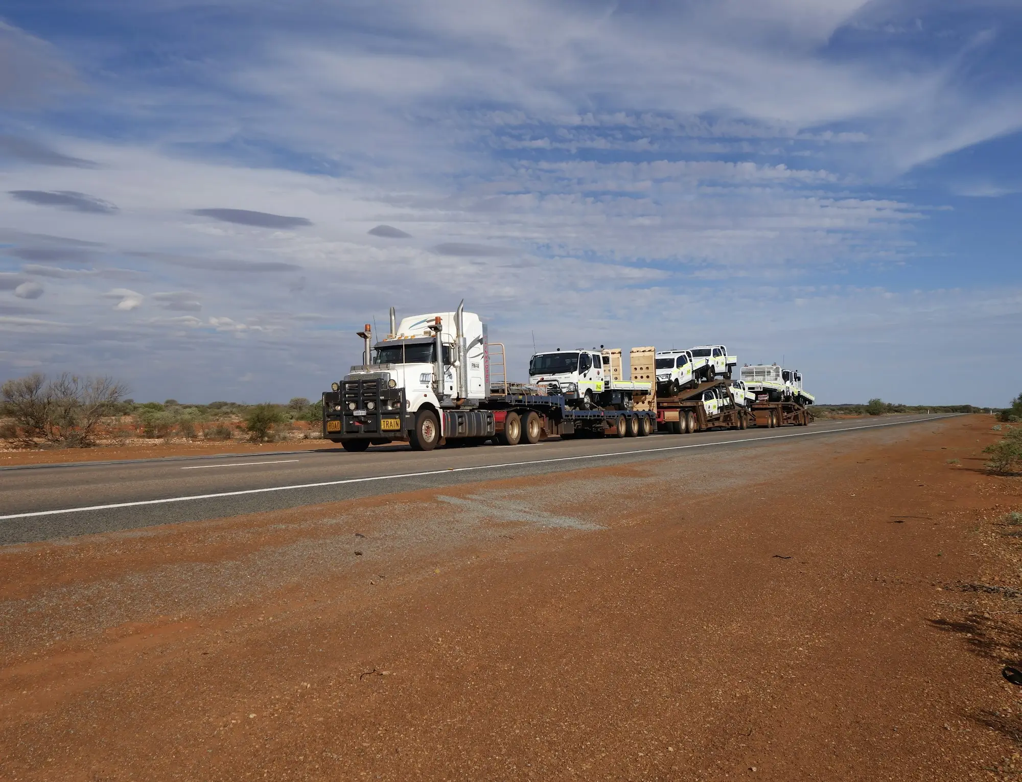 Semi-trailer stopped on the shoulder of an Australian highway with hazard lights on